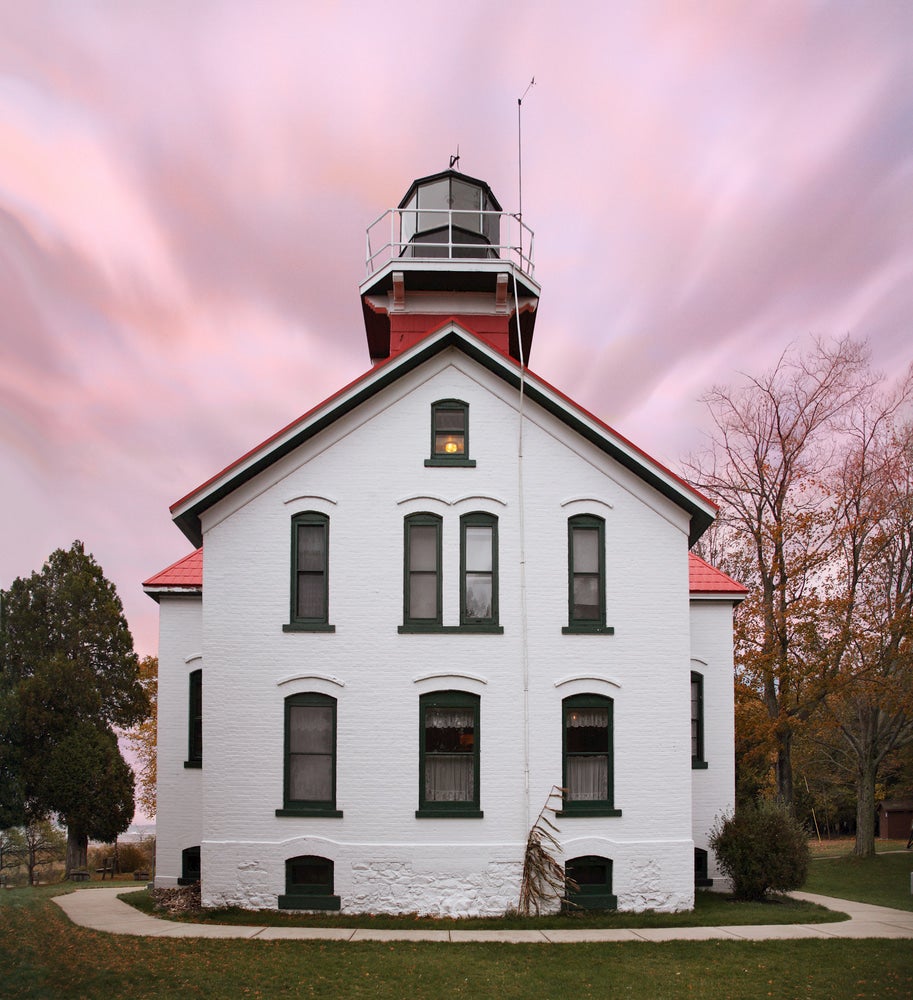 he The Grand Traverse Lighthouse at dusk Leelanu State Park.