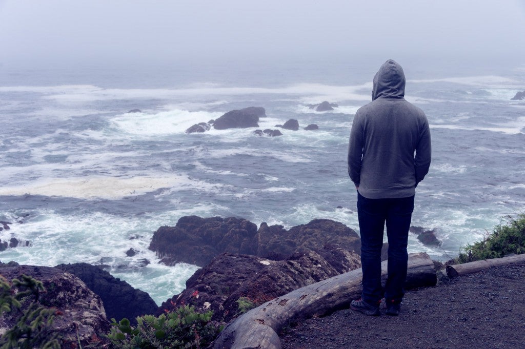 Person looking out at the ocean on a stormy day.