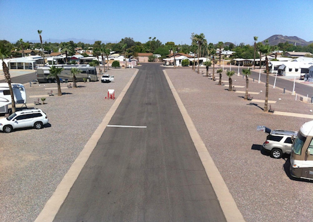 RV Park with palm trees and mountains in the background.