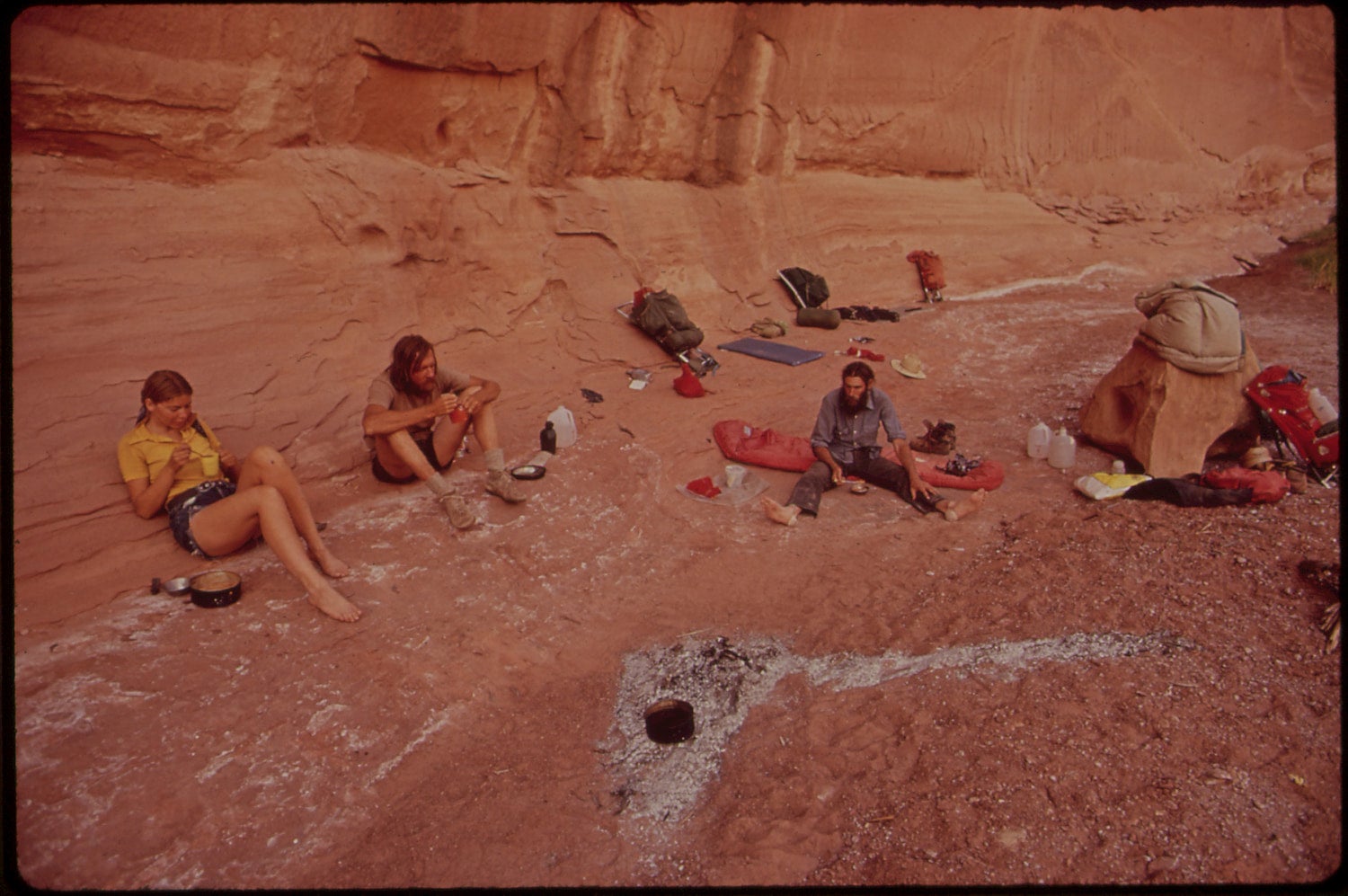 backpackers taking a break with their gear spread around in the maze at canyonlands