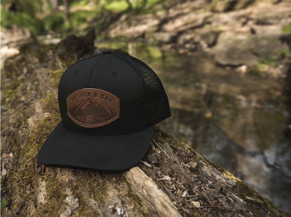 Black hat on a log outdoors.