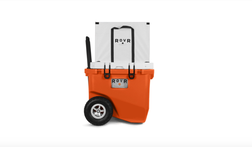 Orange rovr cooler with all terrain wheels and pop up handle.