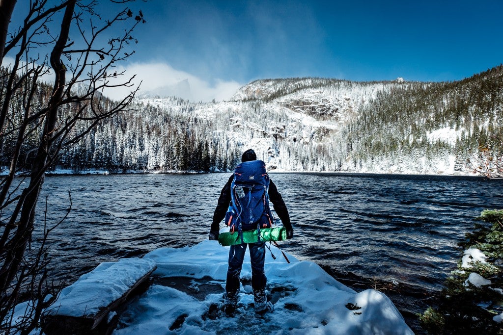 Backpacker hiking through Rocky Mountain National Park in the winter.
