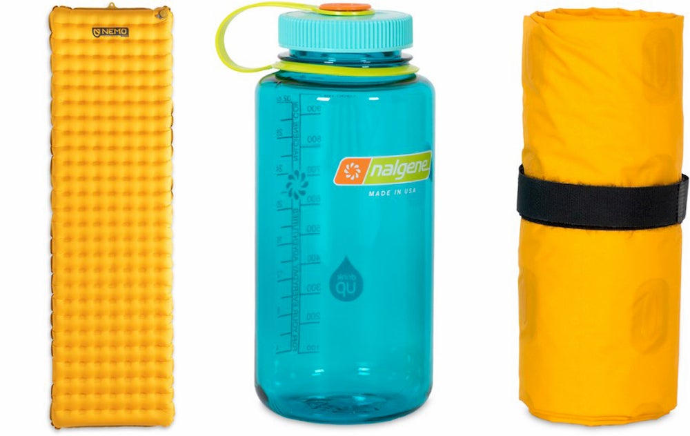 Sleeping pad beside water bottle beside collapsed sleeping pad.