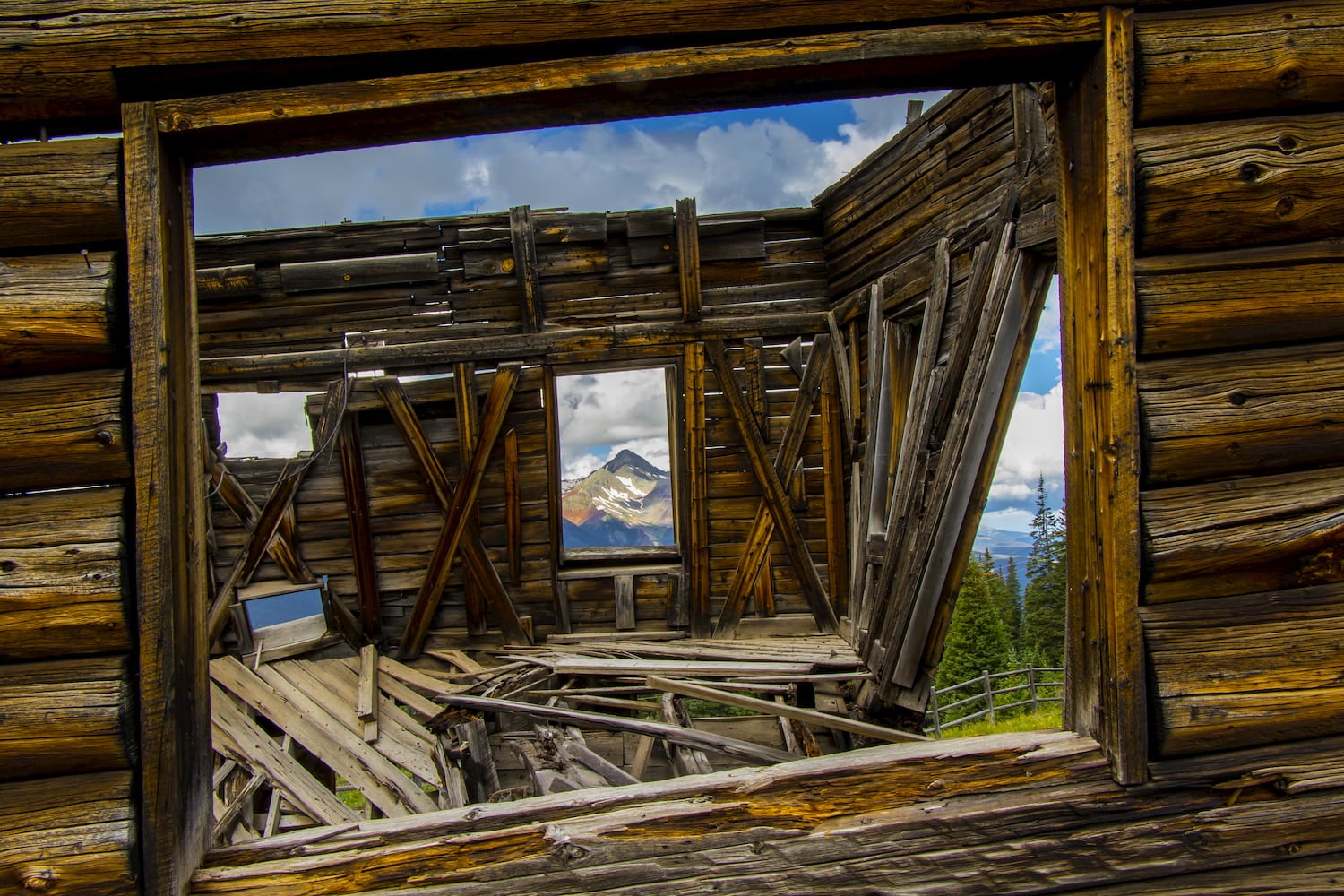 Telluride in Colorado's San Juan Mountains, summer - abandoned mining structure at ghost town of Alta with Wilson Peak viewed through window.