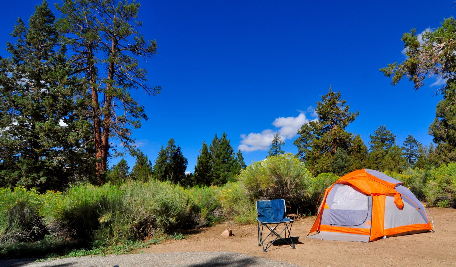 photo of camp chair and tent at campsite