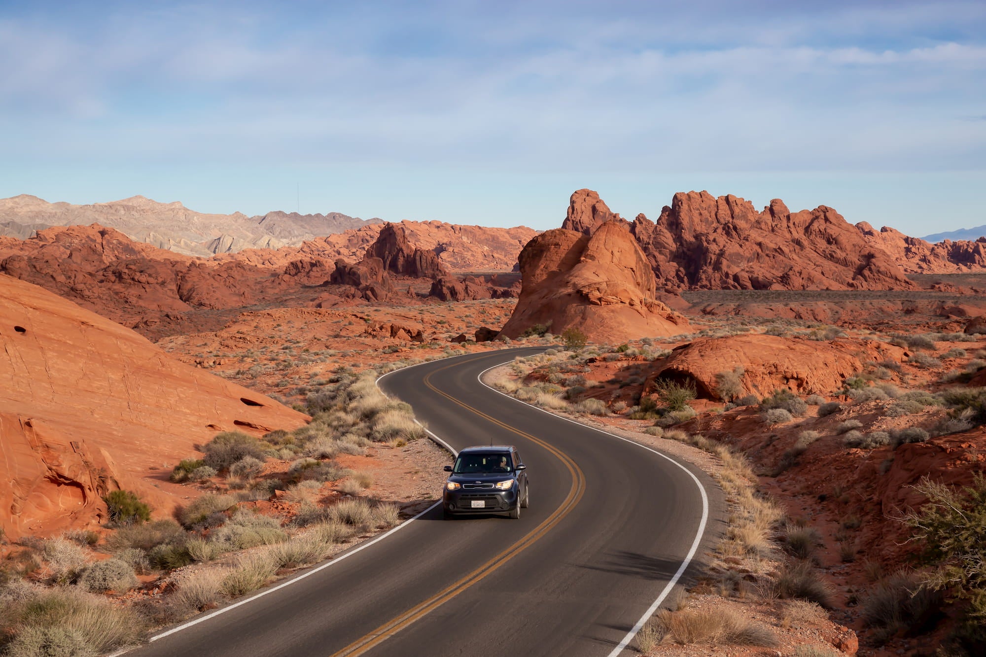 car driving on road through valley of fire state park