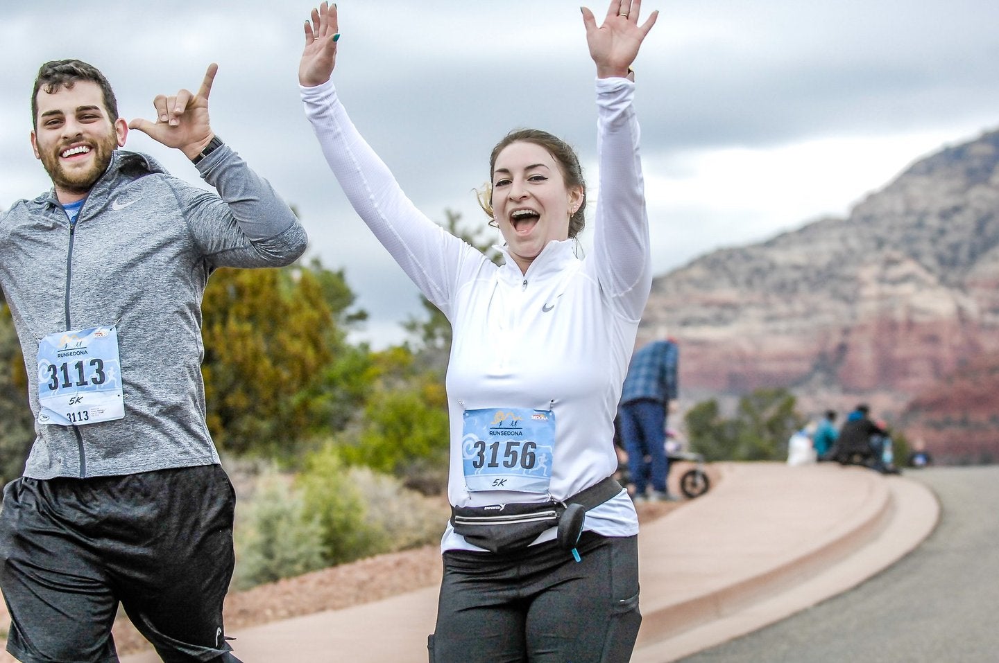 man and woman running in race excitedly