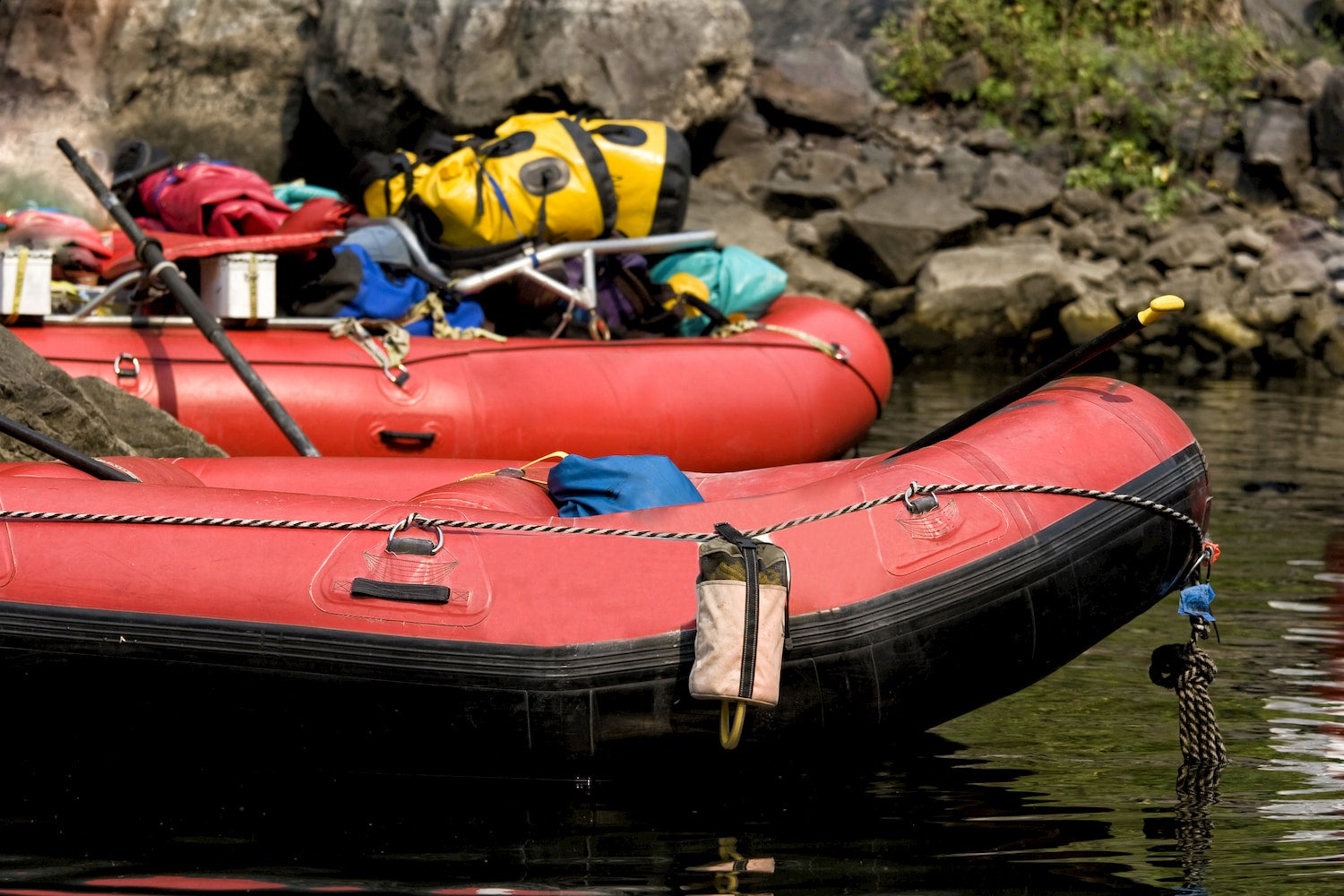 line-up of rafts with gear on them