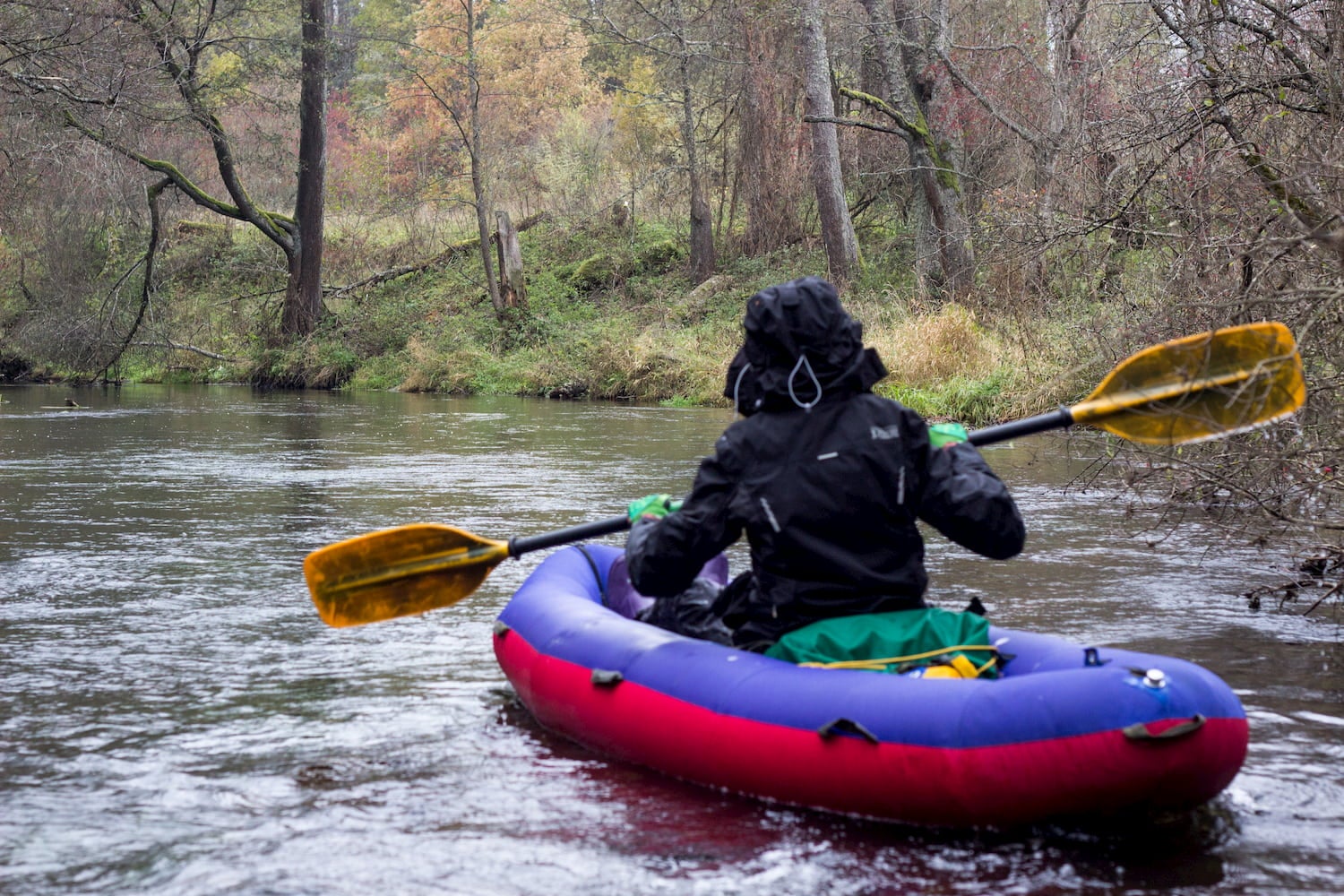 man pack rafting down river