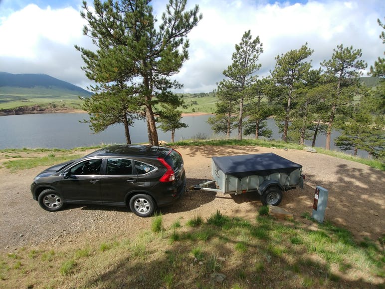 car and trailer at campsite
