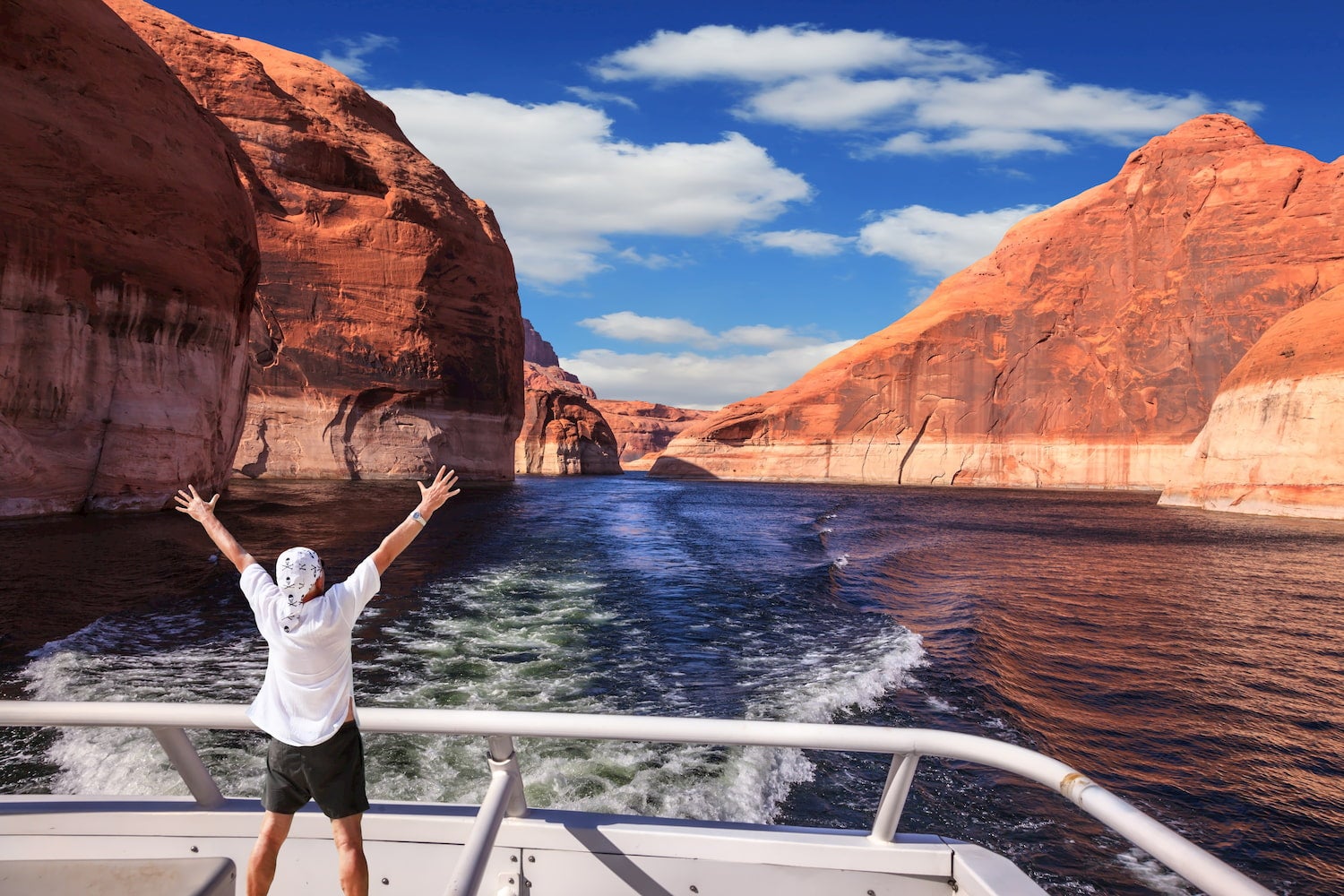 man at side of boat on lake powell