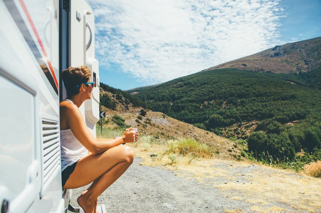 Woman drinking coffee outside of RV