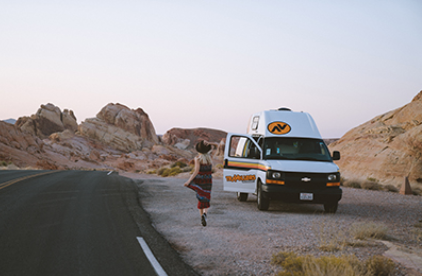 Women running towards van in the desert.