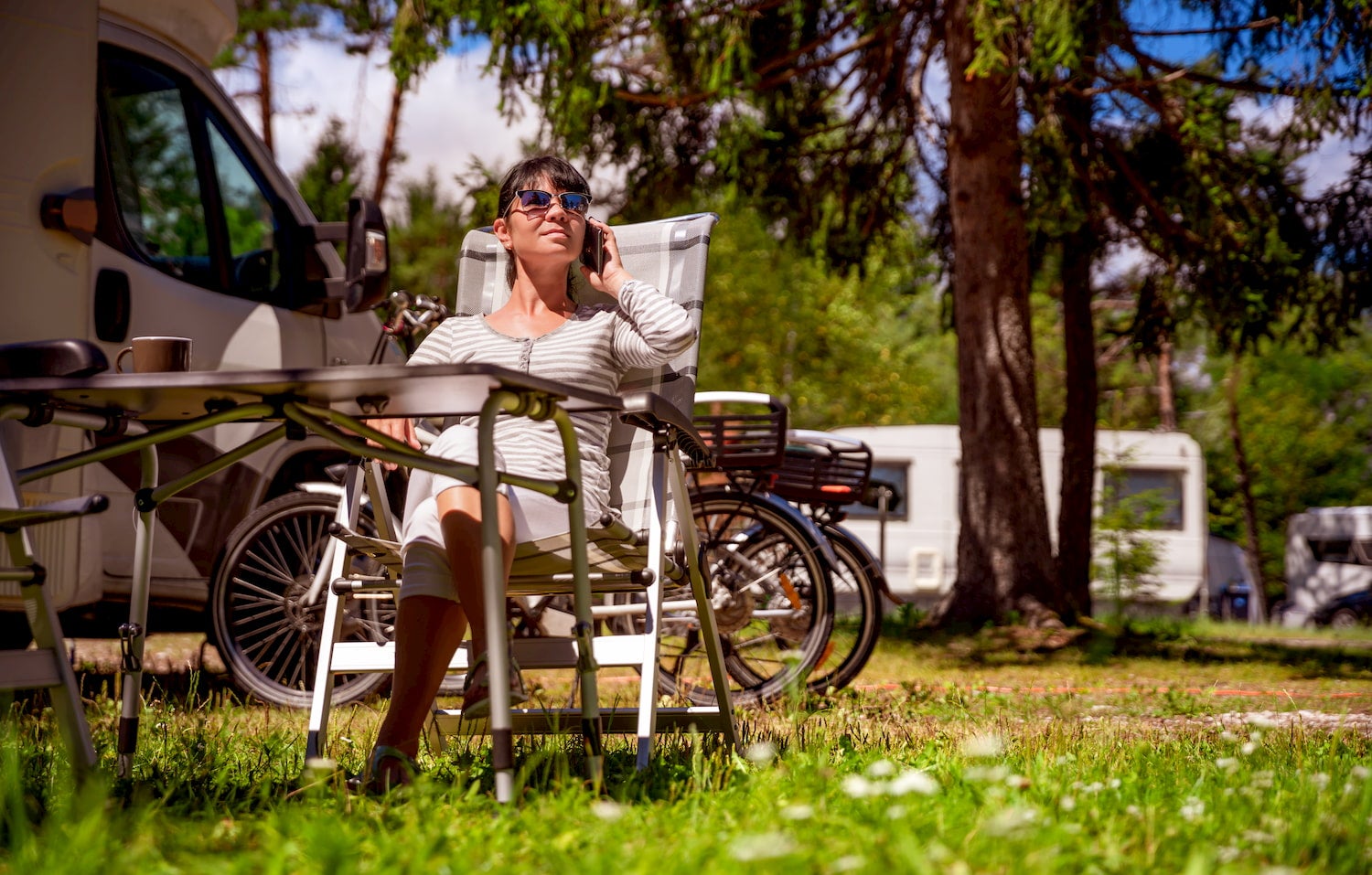 woamn talking on her phone outside an rv