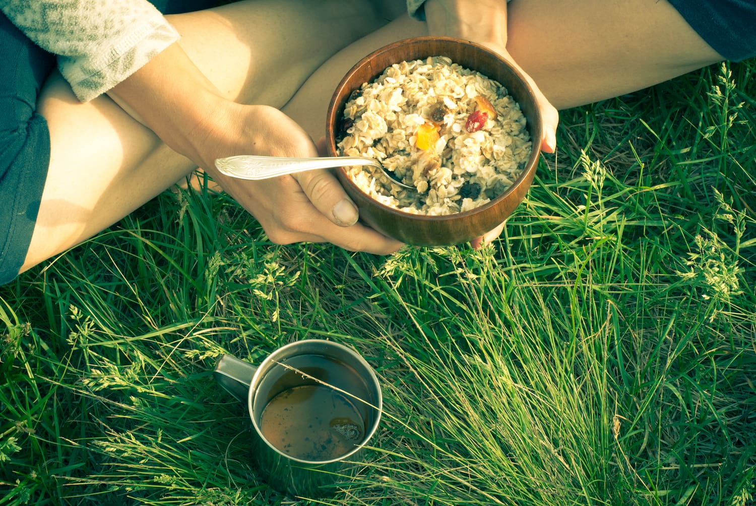 someone holding pot of oatmeal in grass