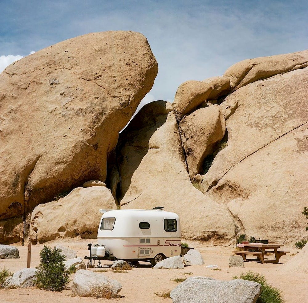 Small trailer with red rocks in background