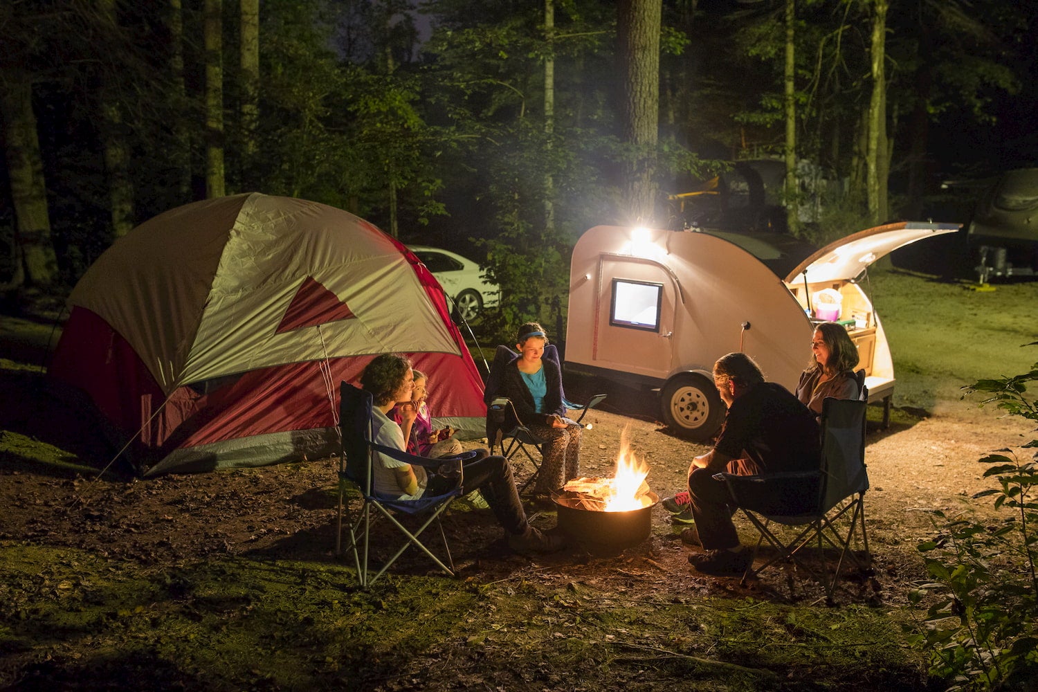 family around campfire at night