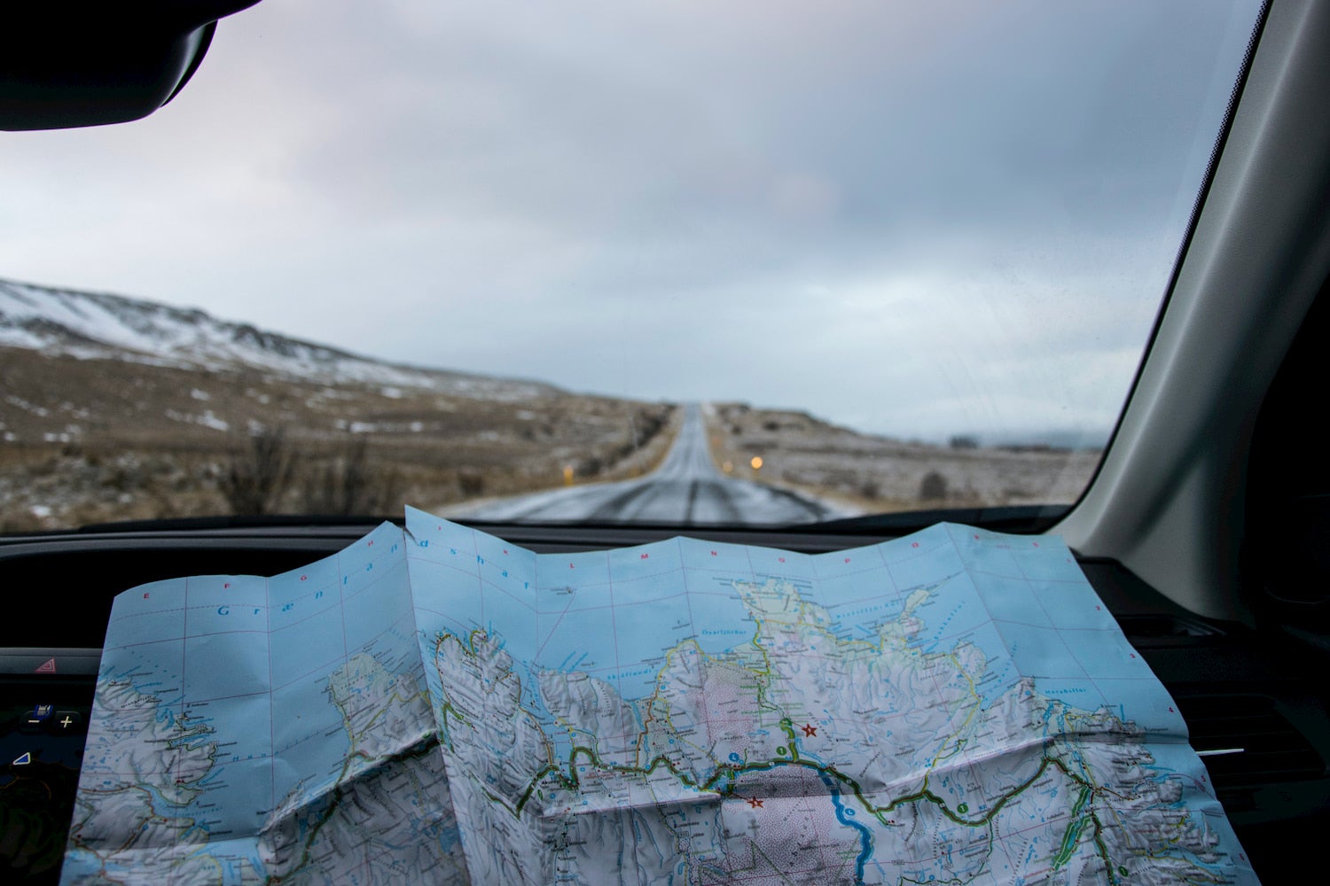 Paper map on a car dashboard, a road trip essential for no wifi zones.