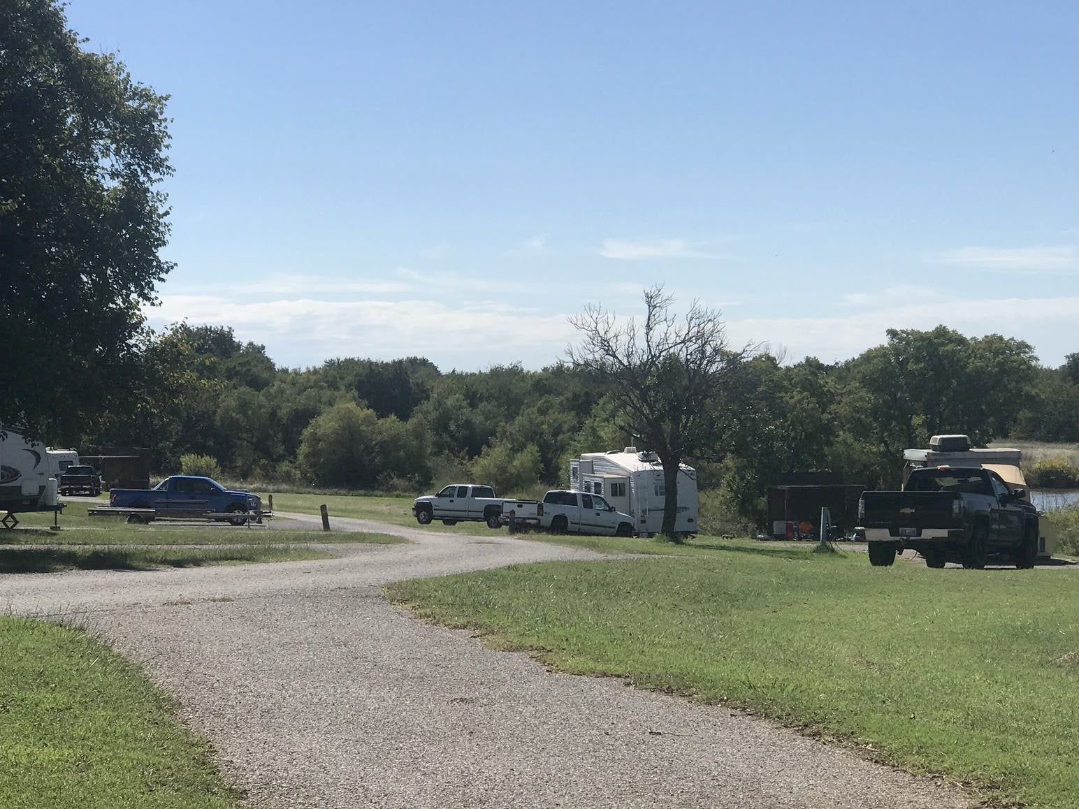 RV parl and campsite inn green field with surrounding forest.