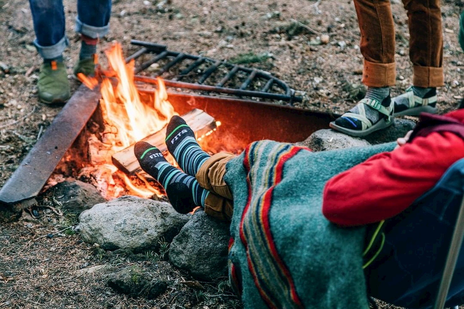 Wool hiking socks used while camping beside a fire.