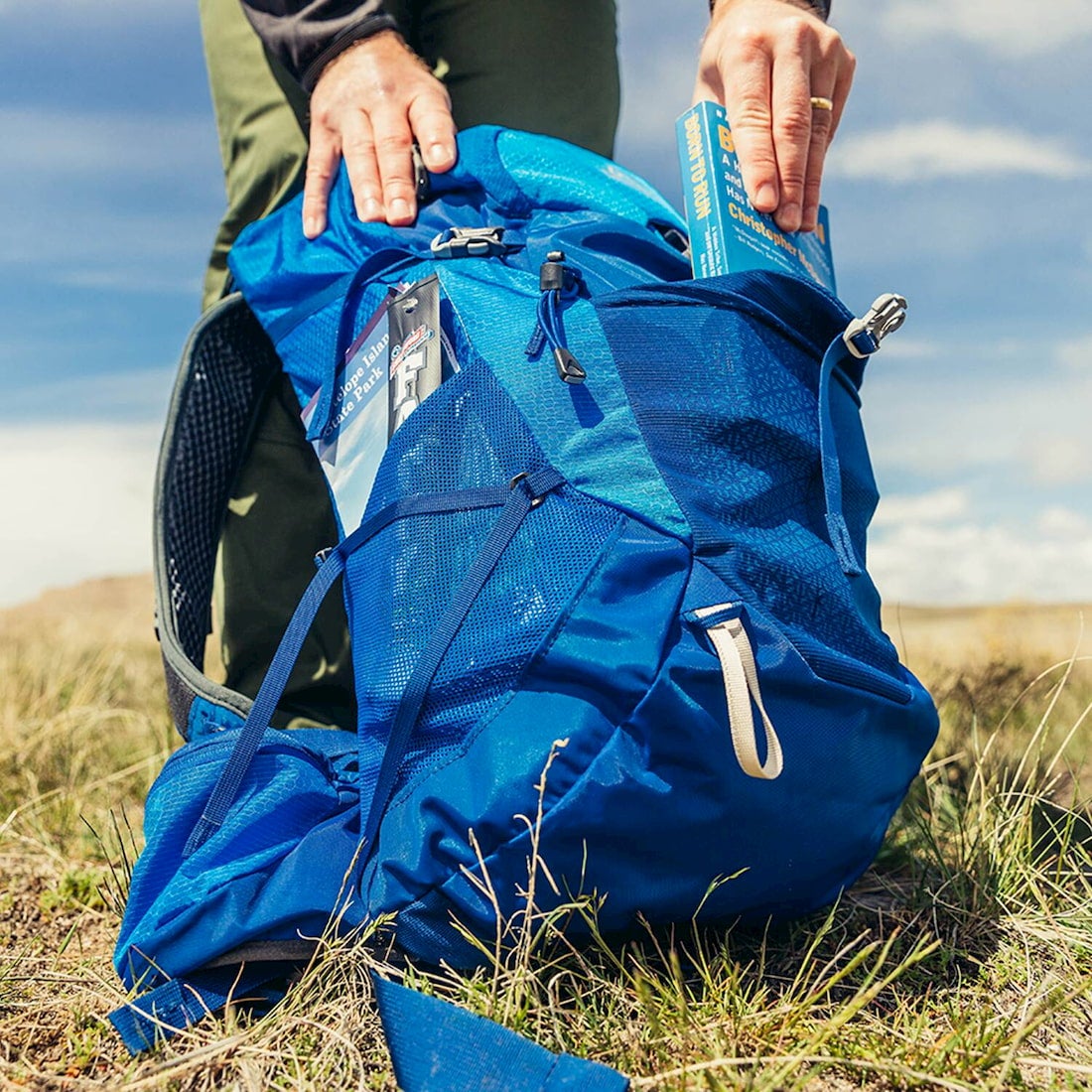 citro 24 jbackpack with book being placed in front pocket