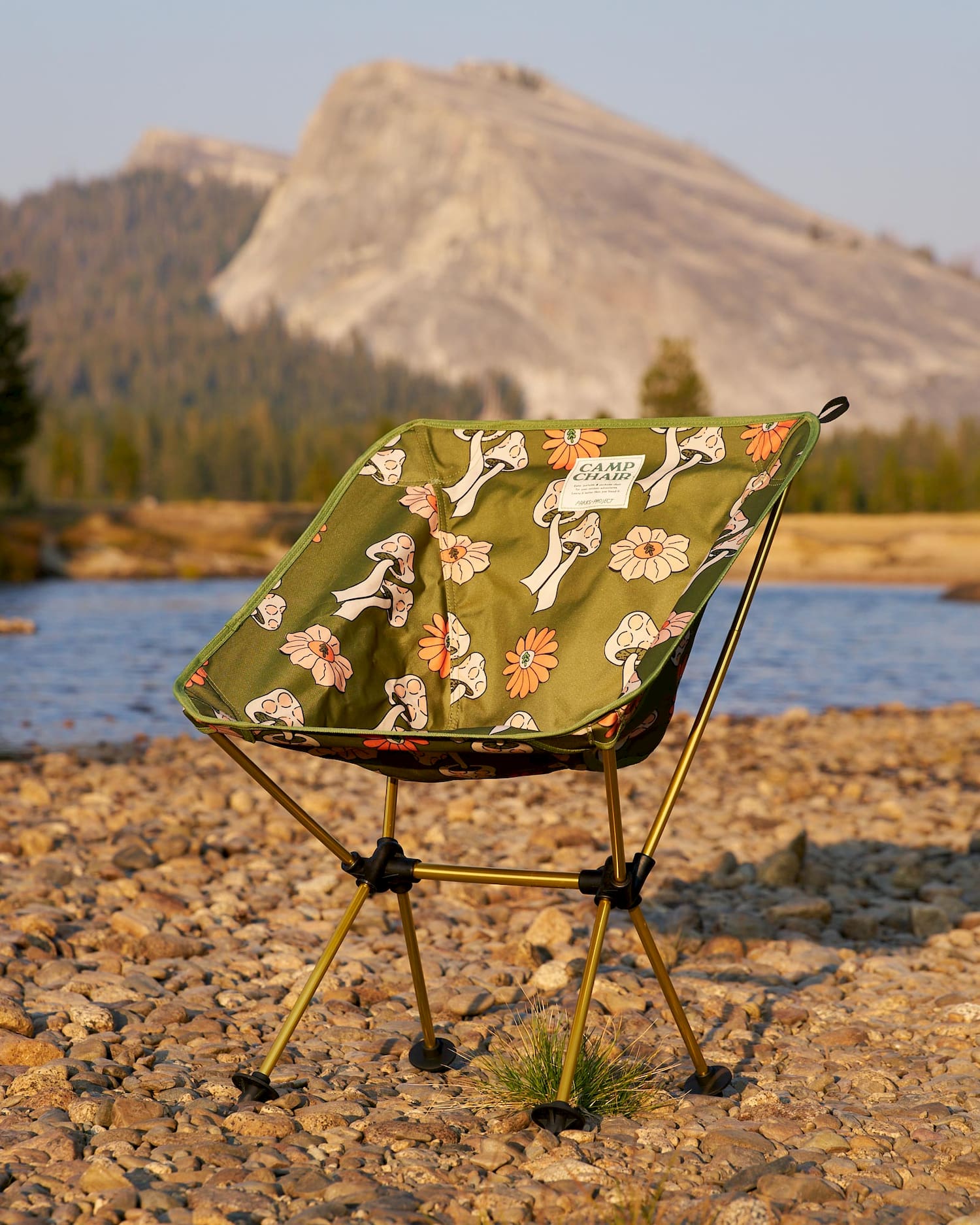 shrooms packable chair infront of water and rock