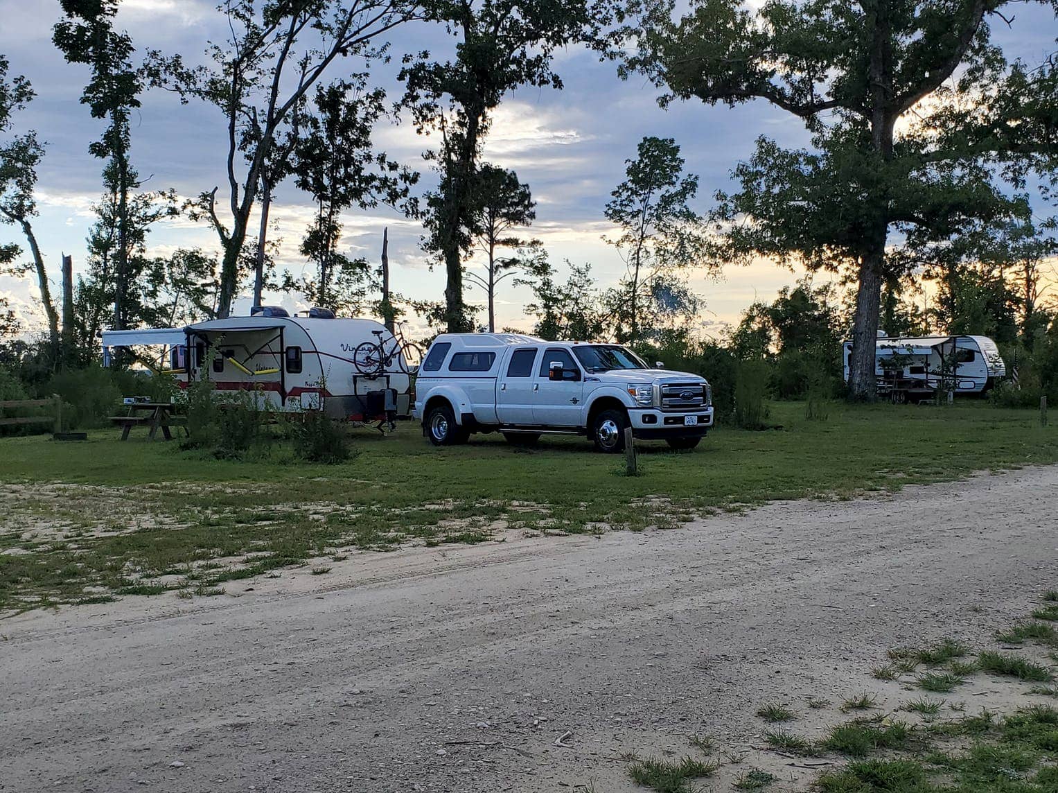 Pick up truck with RV trailer parked at campsite at Torreya State Park.