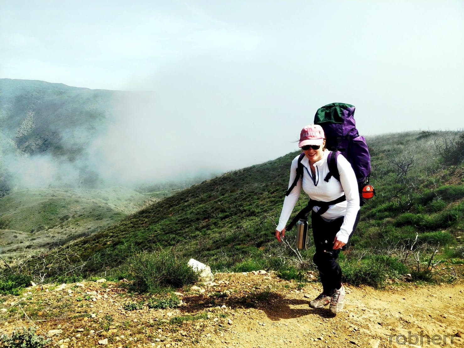 Backpacker hiking in La Jolla Valley, California.