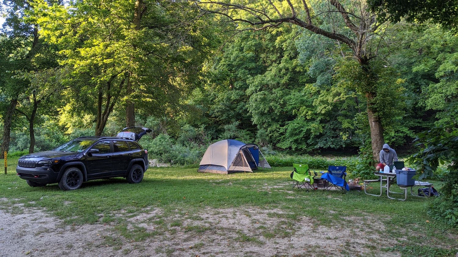 tent campsite set up under trees