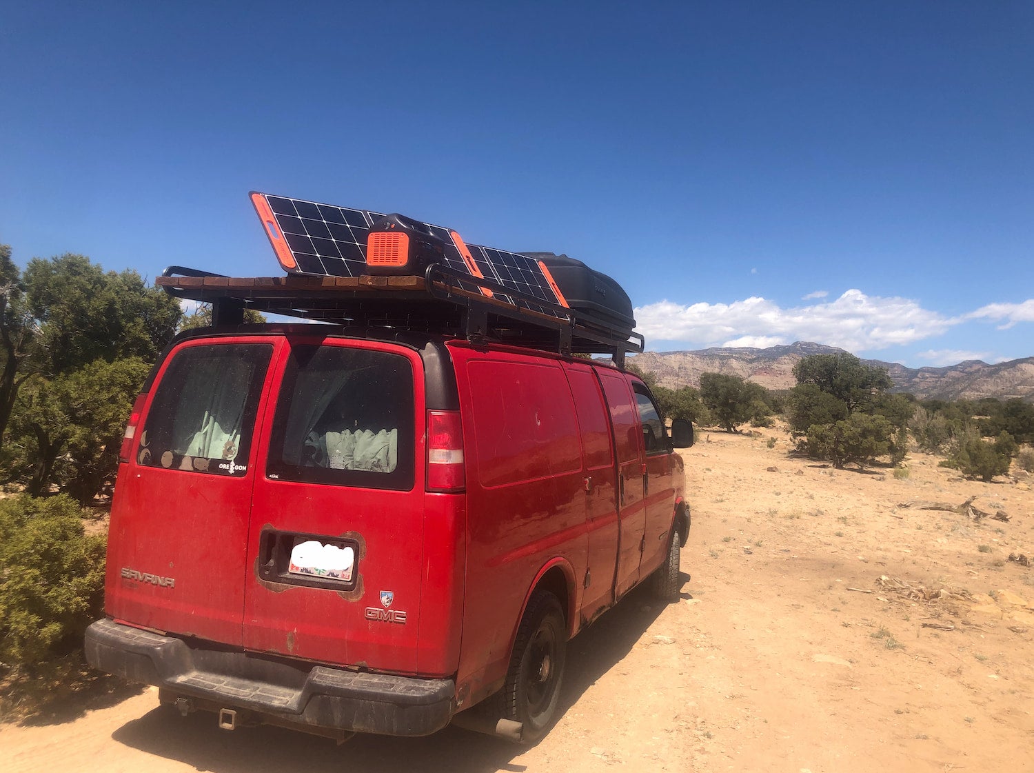 van with solar panels on top charging