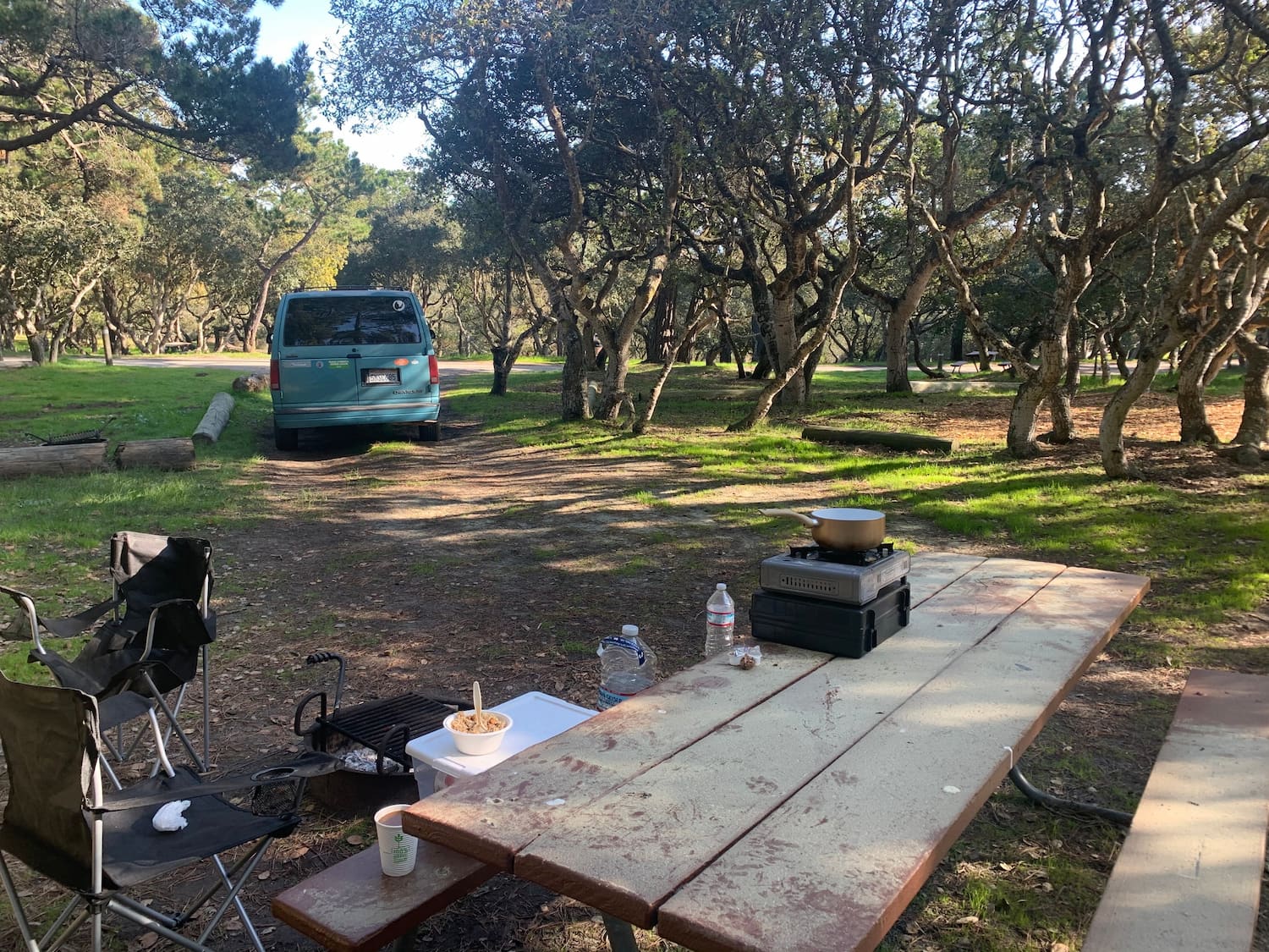 van and camp set up at picnic table
