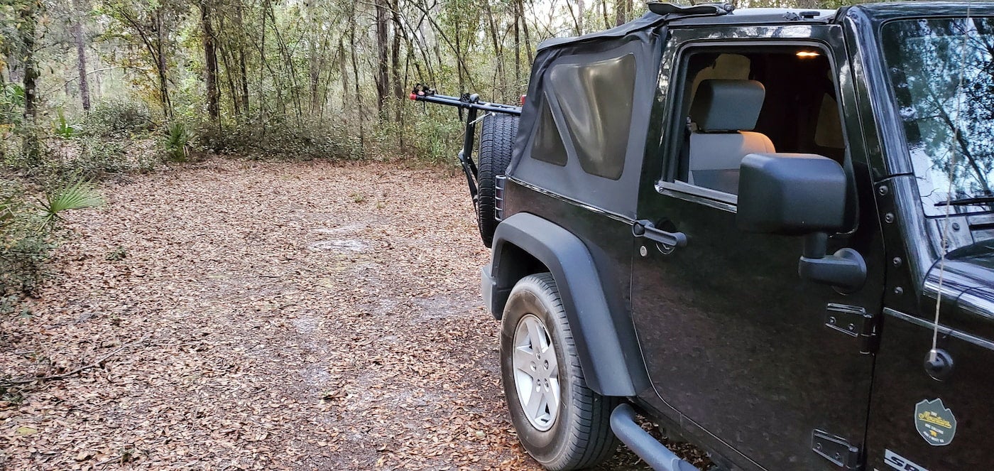 Jeep wrangler at forested florida campsite.