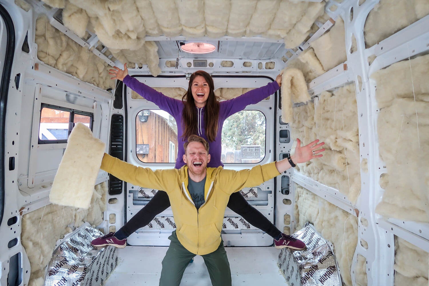 Katie and Ben of Two Wandering Soles building out their camper van.