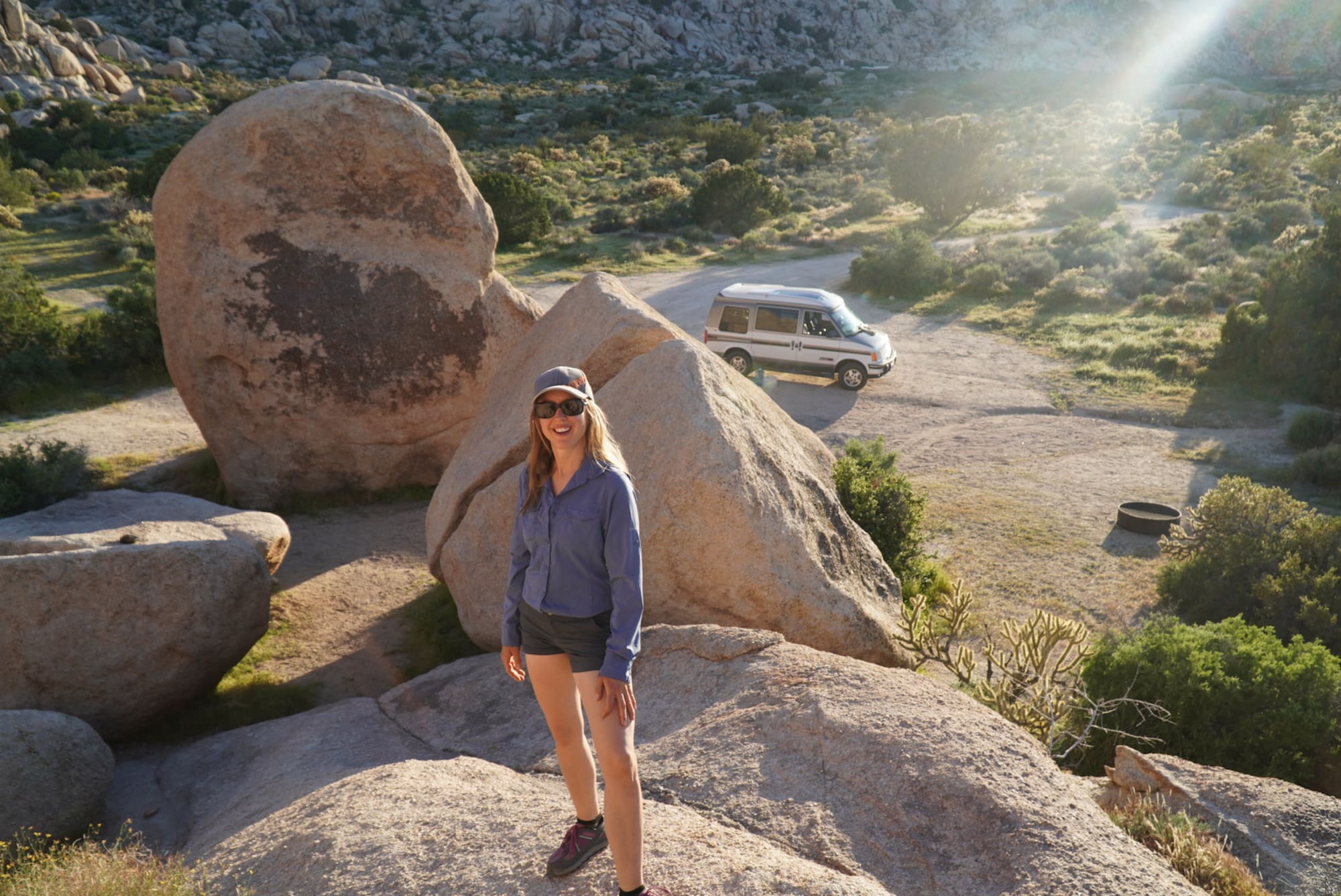 Kristin Hanes of The Wayward home at a Joshua Tree campsite with her van.