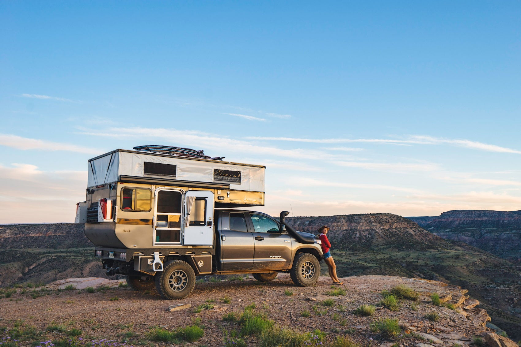 Bound for Nowhere's current rig a toyota tundra truck with pop up camper parked at the edge of a canyon.