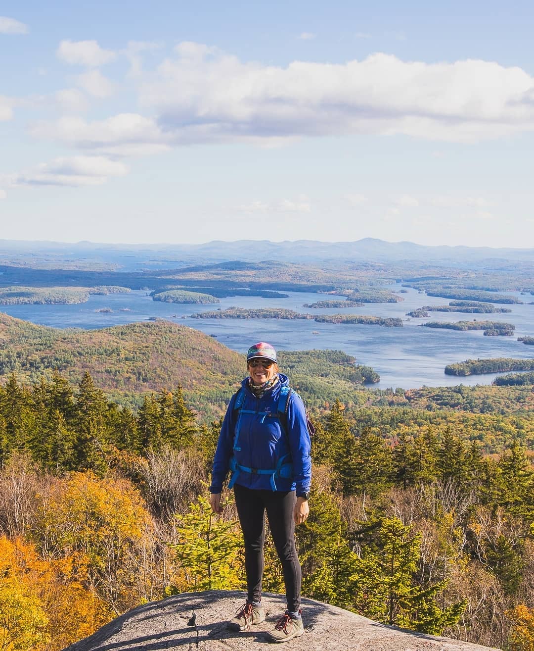 Kristin Bor founder of Bearfoot Theory blog hiking in the mountains of New Hampshire in the fall.