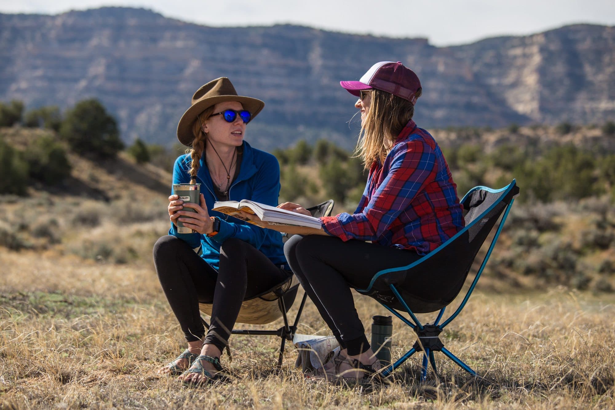 Women sitting in camping chairs.