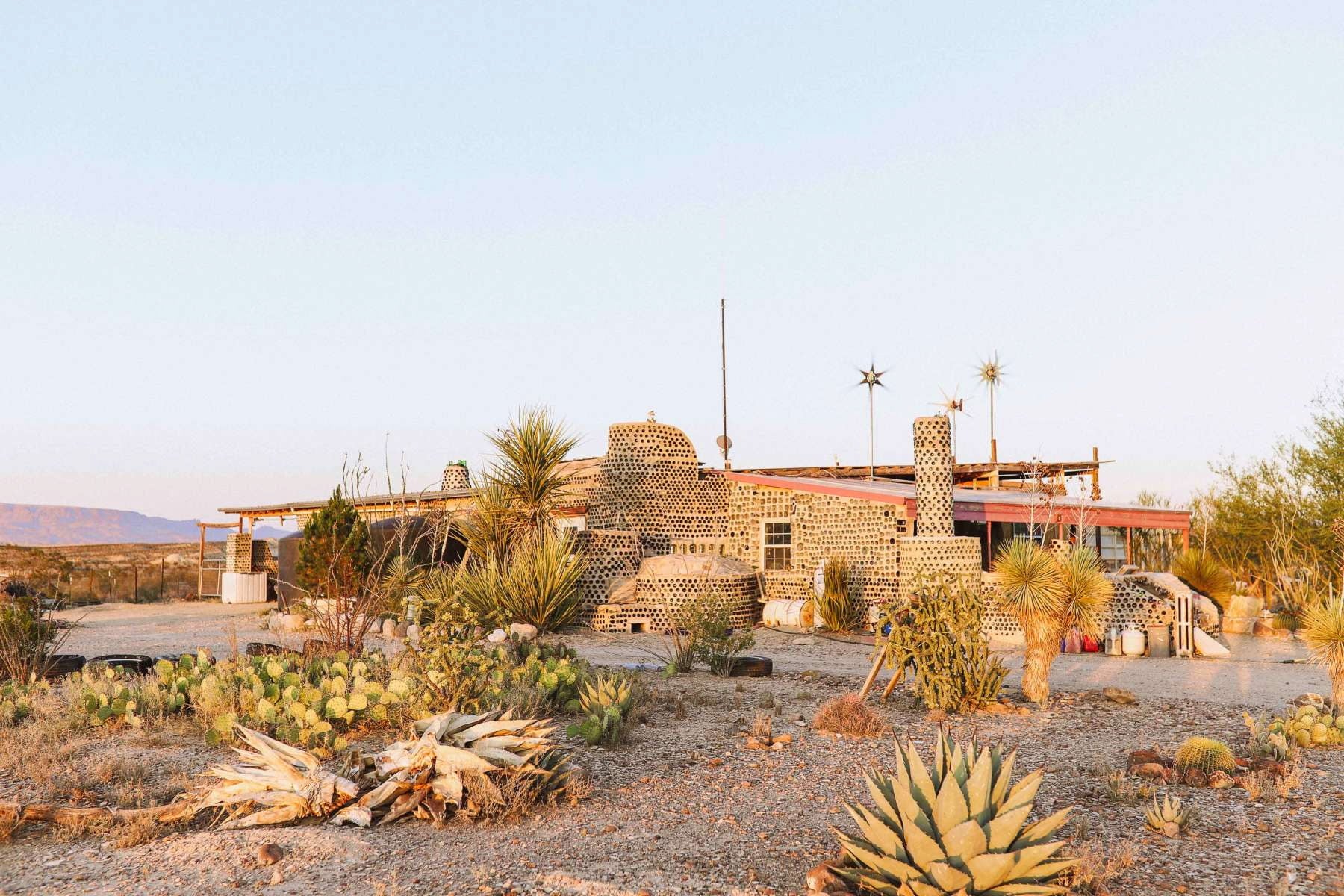 Eco ranch main cabin made out of recycled materials in the desert.