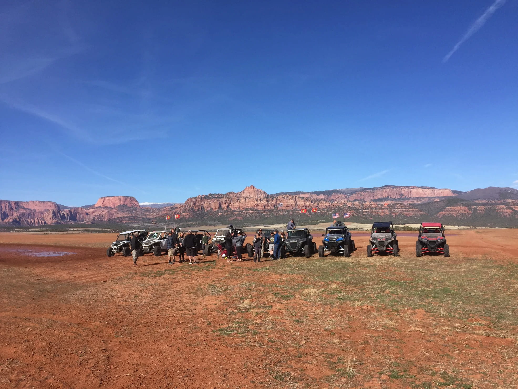 4 runners parked in a line in the desert with mountains in the distance.