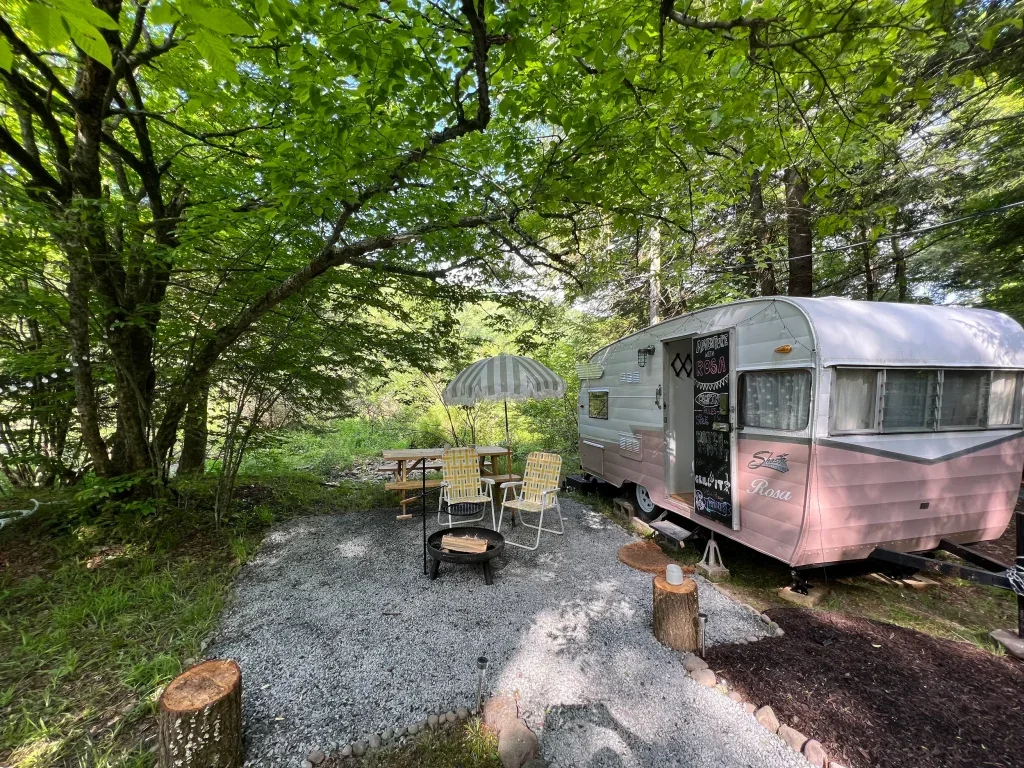 Vintage trailer parked at a cozy campsite