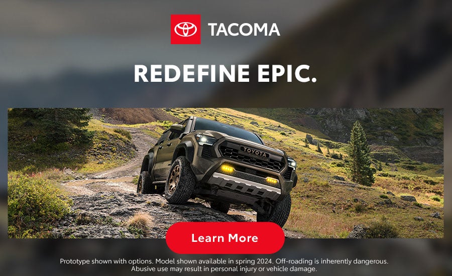 Toyota Tacoma driving up rocky terrain